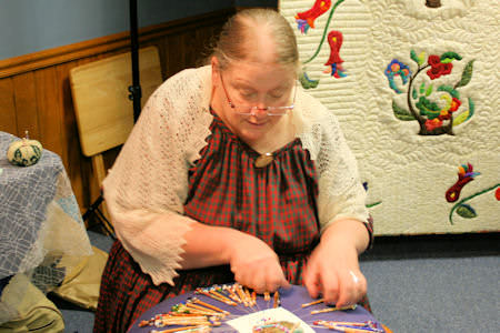 Demonstrating lace making