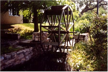 A decorative water wheel representing the gristmill once powered by The Ditch.